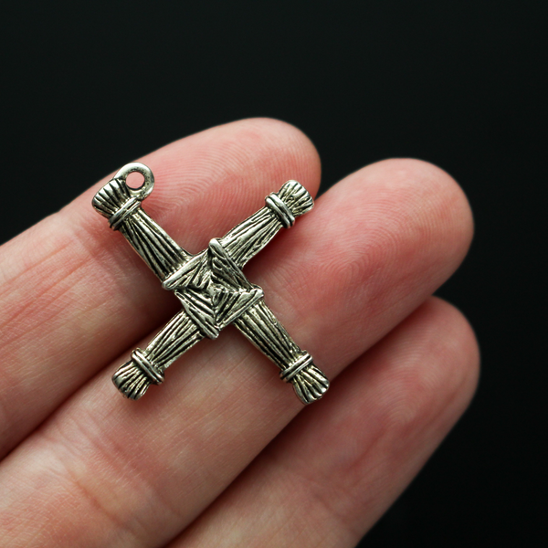 Brigid's cross charm 1-1/8" long The cross is an antiqued silver-tone color and looks the same on both sides. There is no jump ring attached to the bail