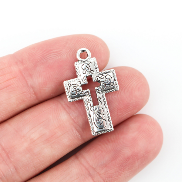 ornate cross charm with cutout cross in center