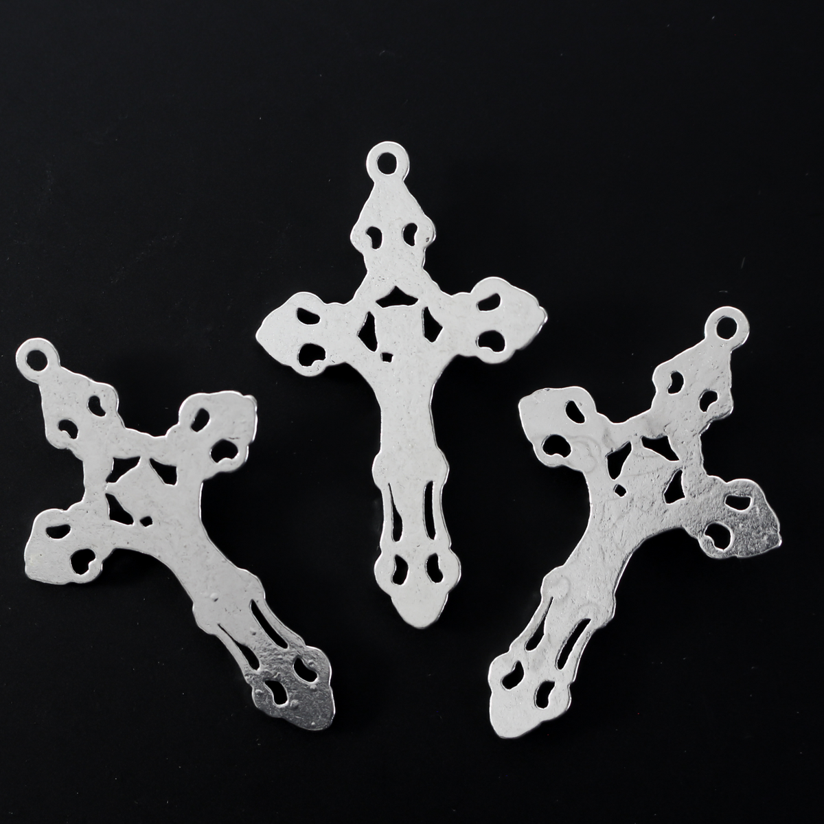 Three ornate fleur de lis crucifix cross in an antiqued silver-tone color and filigree cut out design