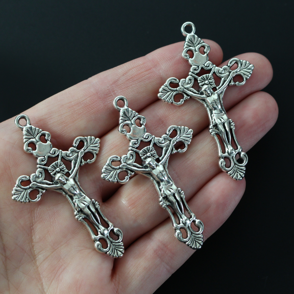 Three ornate fleur de lis crucifix cross in an antiqued silver-tone color and filigree cut out design