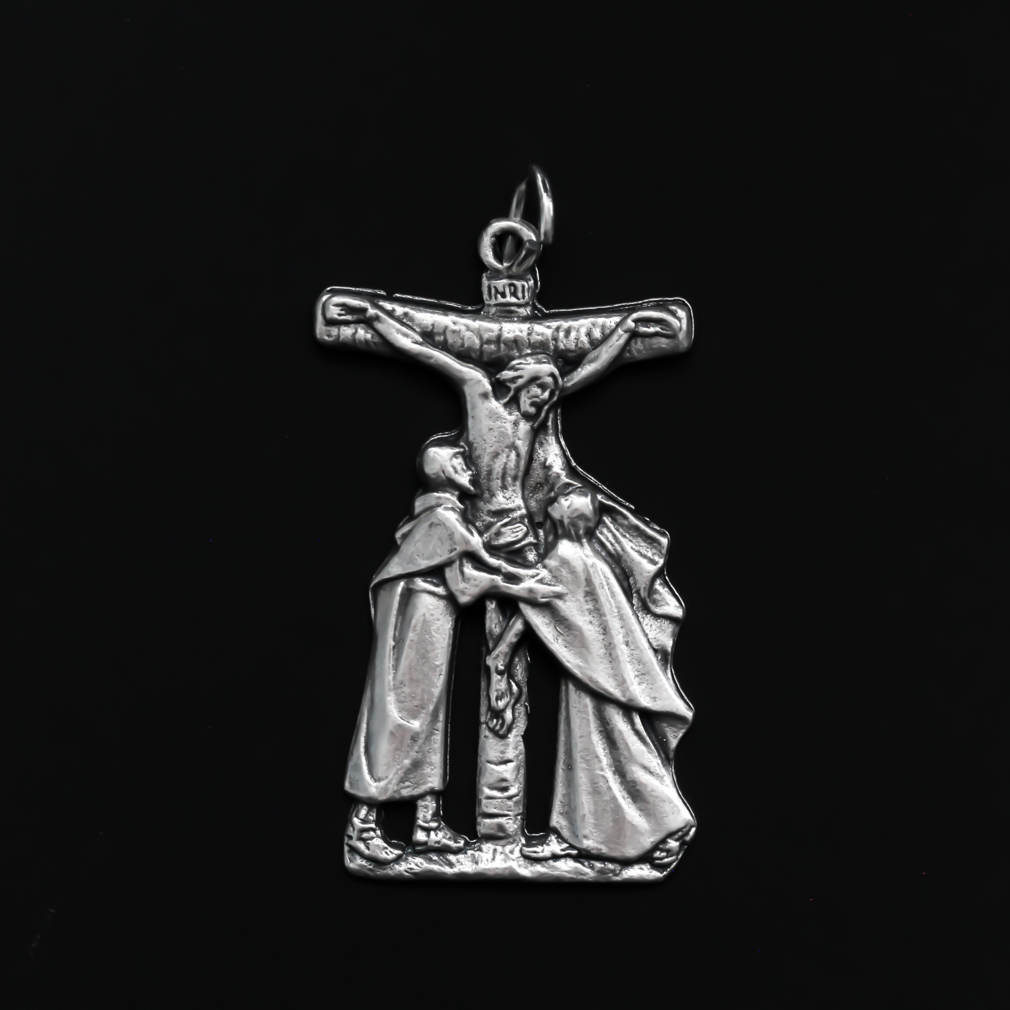 Crucifixion pendant that depicts Christ on the cross between the Virgin Mary and St. John the Beloved