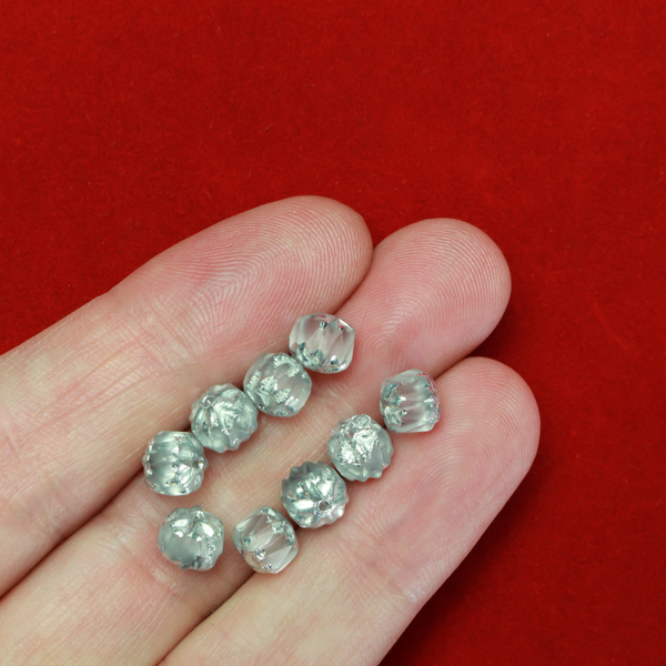 Cathedral shape beads that are clear crystal and faceted. The top and the bottom of the bead are a patterned glass with a silver coating. Made in the Czech Republic. Sold in sets of 20 beads.