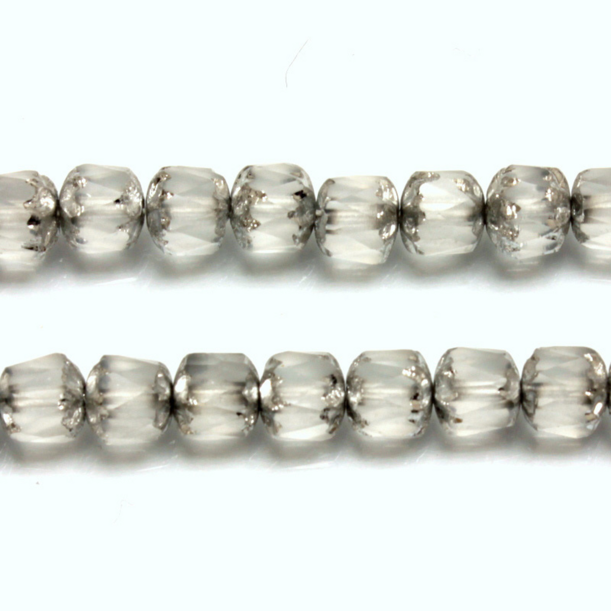 Cathedral shape beads that are clear crystal and faceted. The top and the bottom of the bead are a patterned glass with a silver coating. Made in the Czech Republic. Sold in sets of 20 beads.