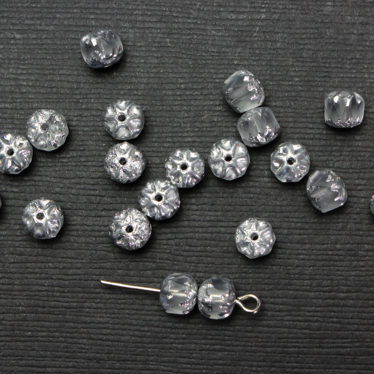 Cathedral shape beads that are clear crystal and faceted. The top and the bottom of the bead are a patterned glass with a silver coating. Made in the Czech Republic. Sold in sets of 20 beads.