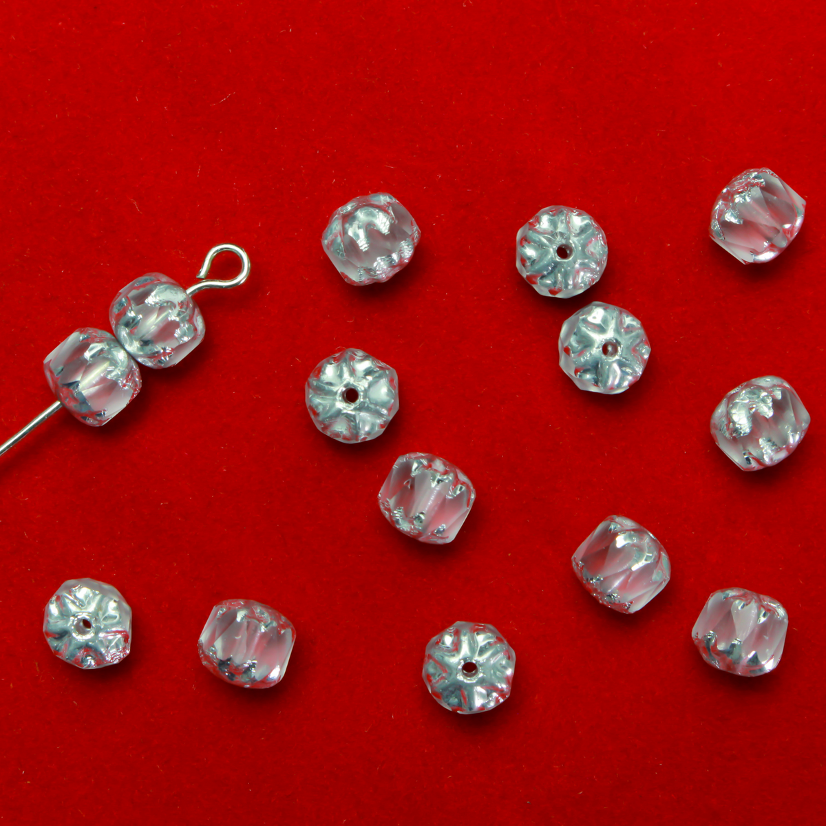 Cathedral shape beads that are clear crystal and faceted. The top and the bottom of the bead are a patterned glass with a silver coating. Made in the Czech Republic. Sold in sets of 20 beads.