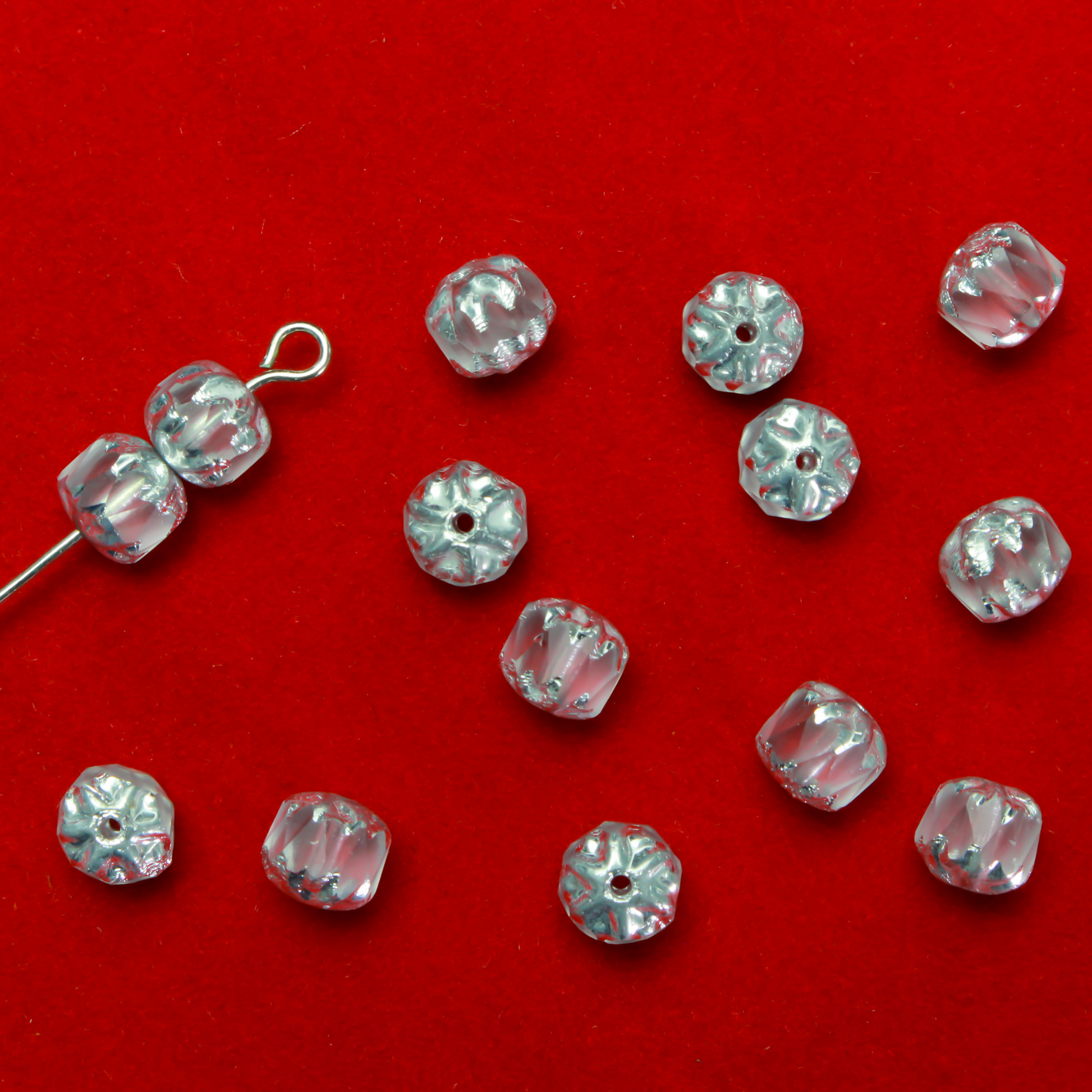 Cathedral shape beads that are clear crystal and faceted. The top and the bottom of the bead are a patterned glass with a silver coating. Made in the Czech Republic. Sold in sets of 20 beads.