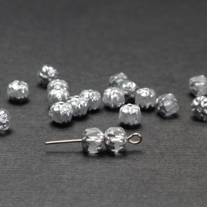Cathedral shape beads that are clear crystal and faceted. The top and the bottom of the bead are a patterned glass with a silver coating. Made in the Czech Republic. Sold in sets of 20 beads.