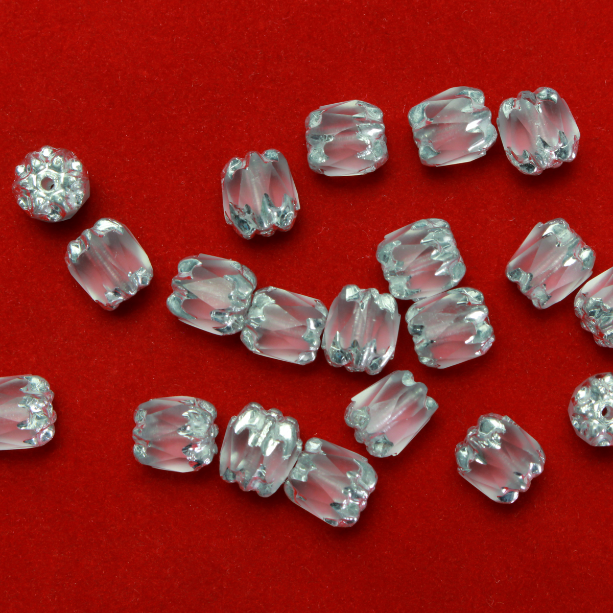 Cathedral shape beads that are clear crystal and faceted. The top and the bottom of the bead are a patterned glass with a silver coating. Made in the Czech Republic. Sold in sets of 20 beads