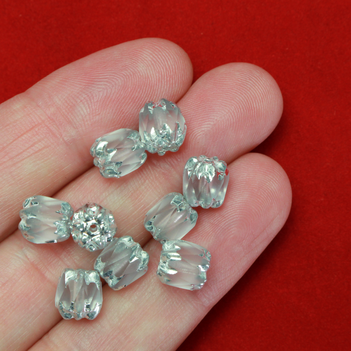 Cathedral shape beads that are clear crystal and faceted. The top and the bottom of the bead are a patterned glass with a silver coating. Made in the Czech Republic. Sold in sets of 20 beads