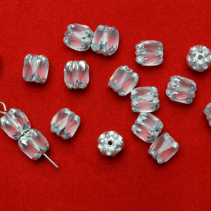 Cathedral shape beads that are clear crystal and faceted. The top and the bottom of the bead are a patterned glass with a silver coating. Made in the Czech Republic. Sold in sets of 20 beads