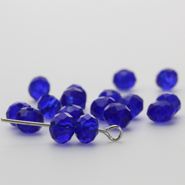 Asian cut crystal glass beads. 6mm x 4mm faceted dark blue transparent. Sold in packages of 60 beads