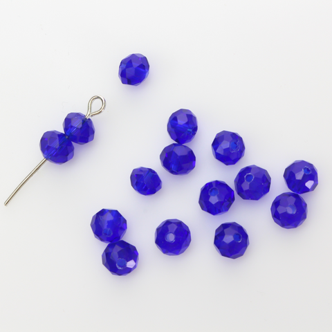 Asian cut crystal glass beads. 6mm x 4mm faceted dark blue transparent. Sold in packages of 60 beads