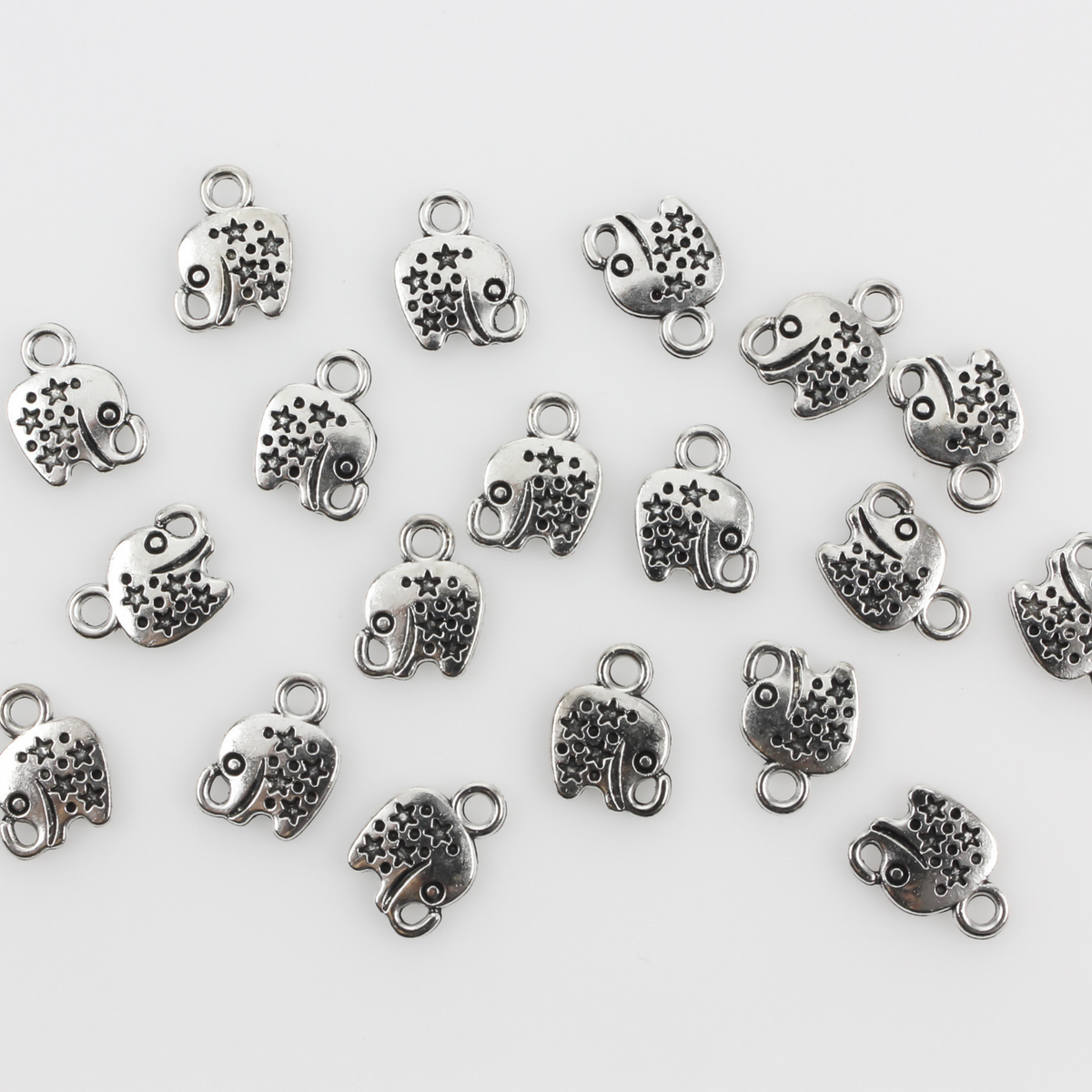 Tiny antiqued silver elephant charms with stars on the body