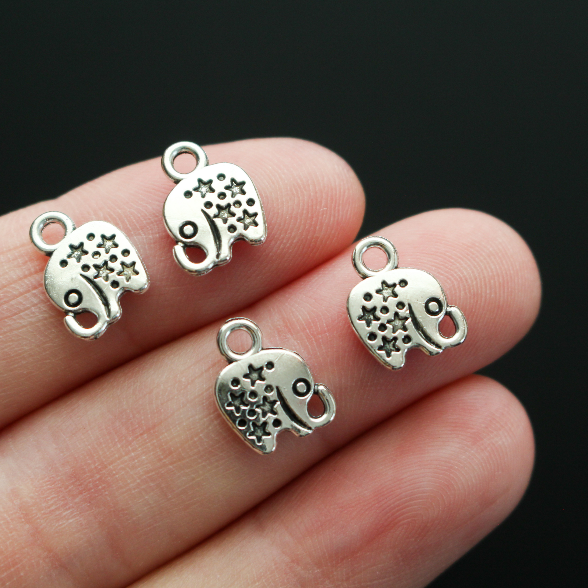 Tiny antiqued silver elephant charms with stars on the body