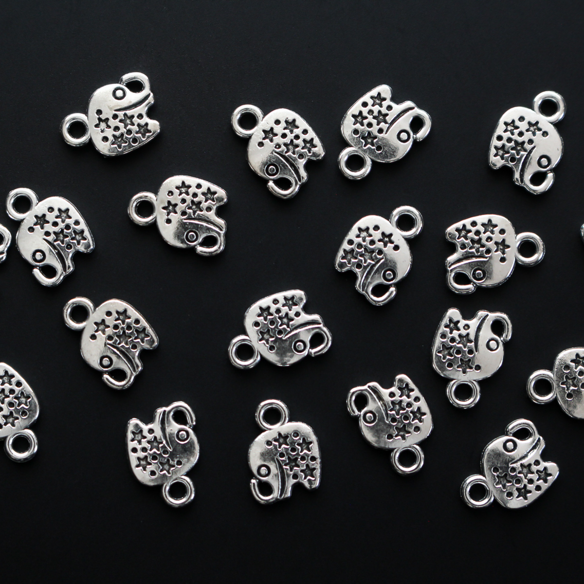 Tiny antiqued silver elephant charms with stars on the body