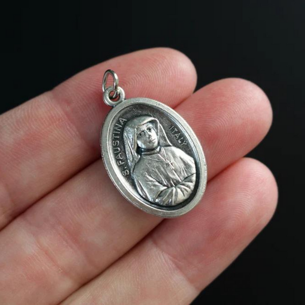 Saint Faustina medal that depicts the saint on the front and the Divine Mercy of Jesus on the backside