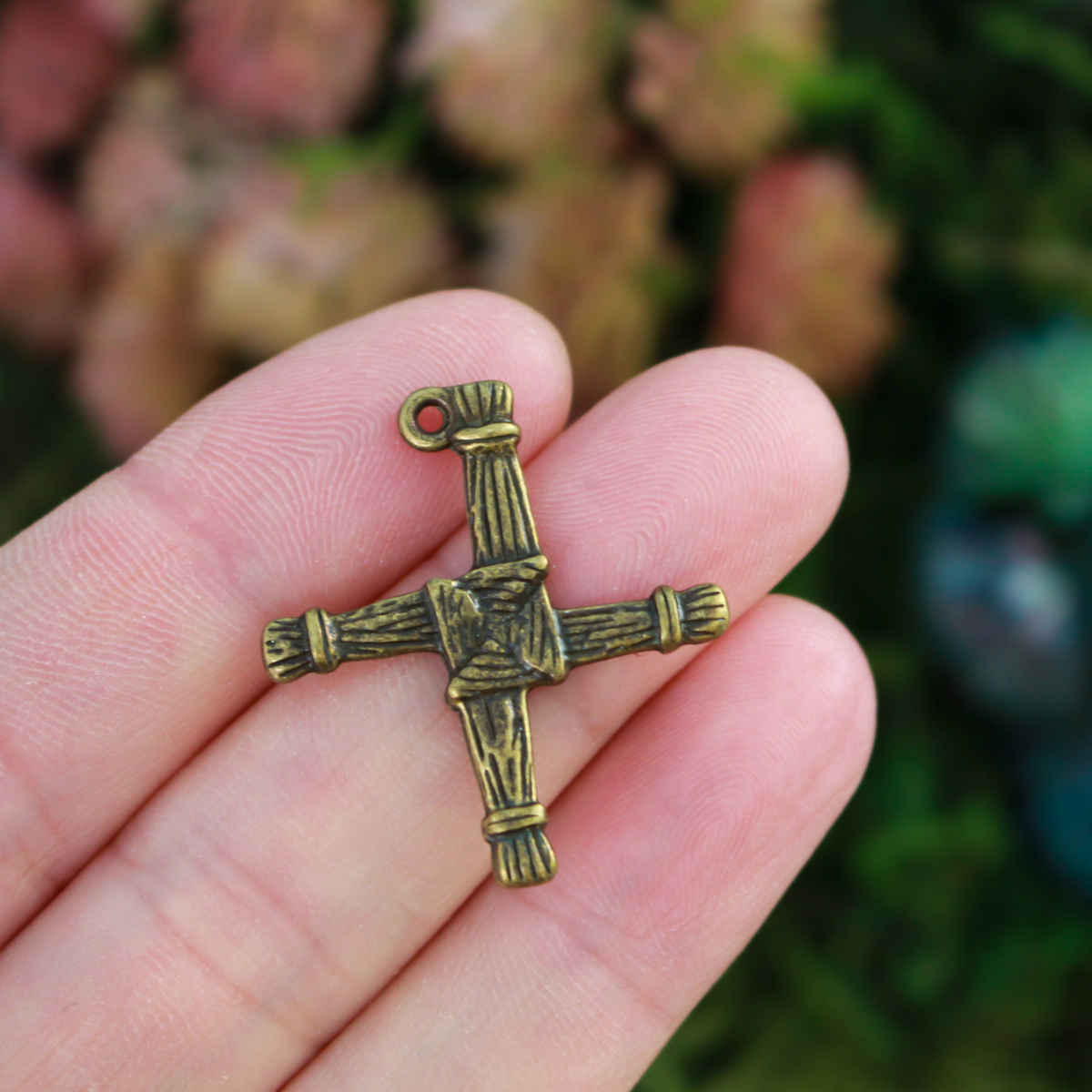 St. Brigid's cross pendant. The cross is an antiqued bronze color and looks the same on both sides. There is no jump ring attached to the bail.