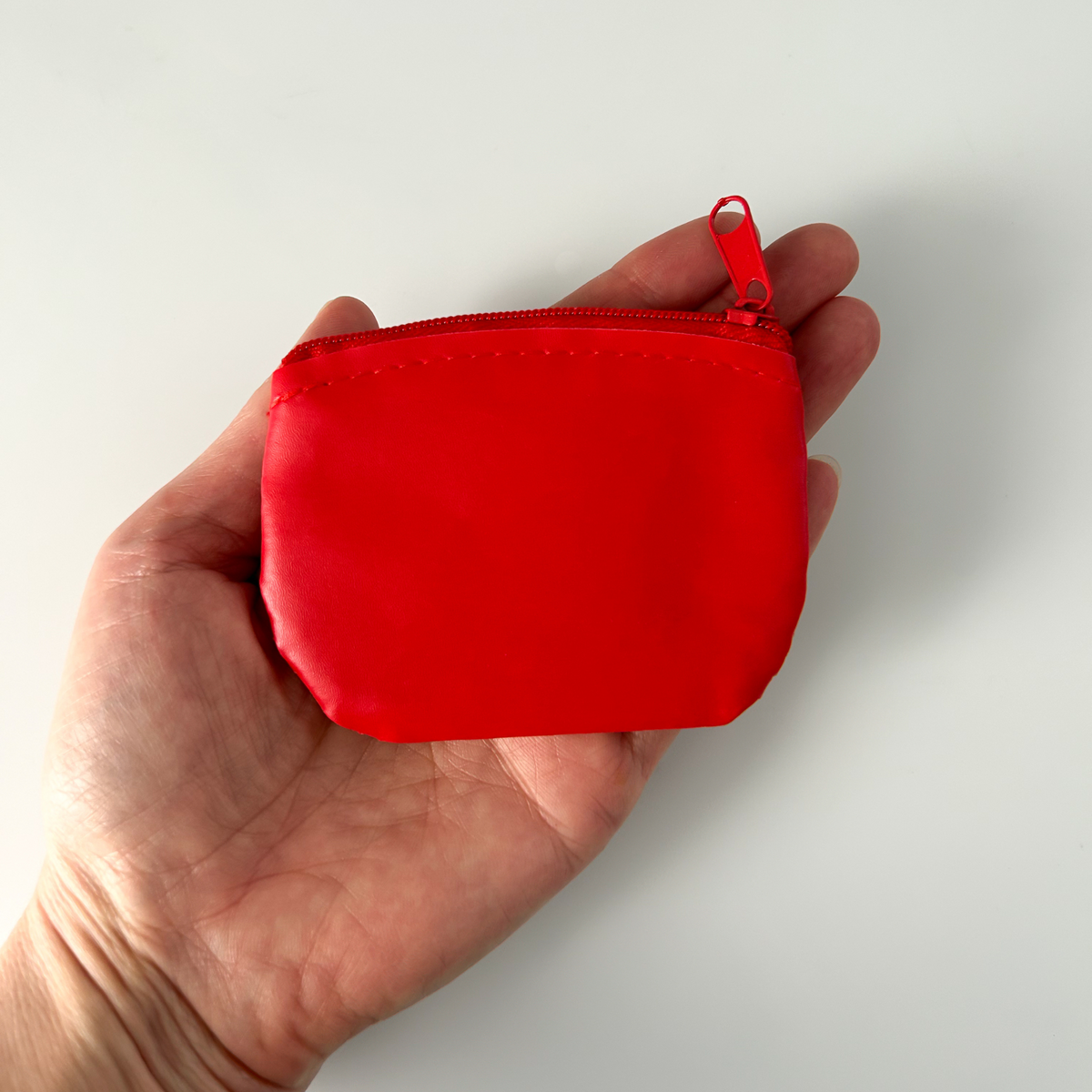 Jesus I trust in you rosary case that is red vinyl with gold lettering and a red metal zipper closure