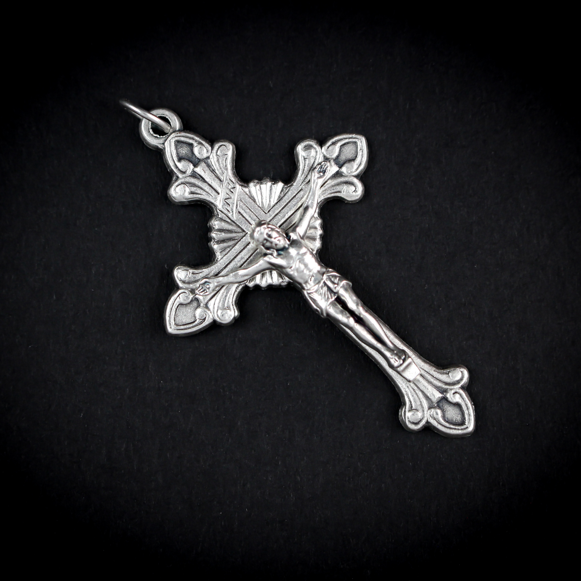 Highly detailed crucifix that features flared edges and a Starburst nimbus behind the crossbeams of the cross.