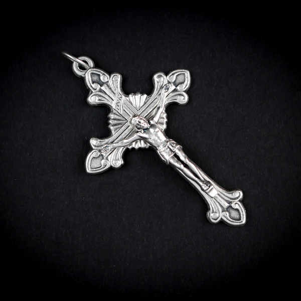 Highly detailed crucifix that features flared edges and a Starburst nimbus behind the crossbeams of the cross.