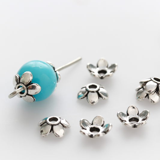 Flower shaped zinc alloy antiqued silver bead caps that are 6mm in diameter