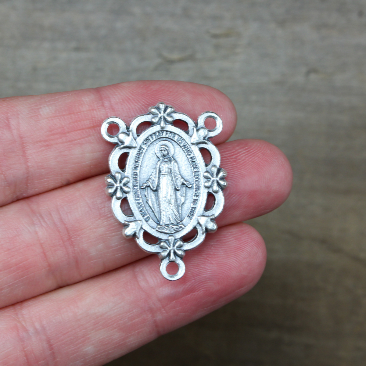 miraculous medal rosary centerpiece with ornate floral border