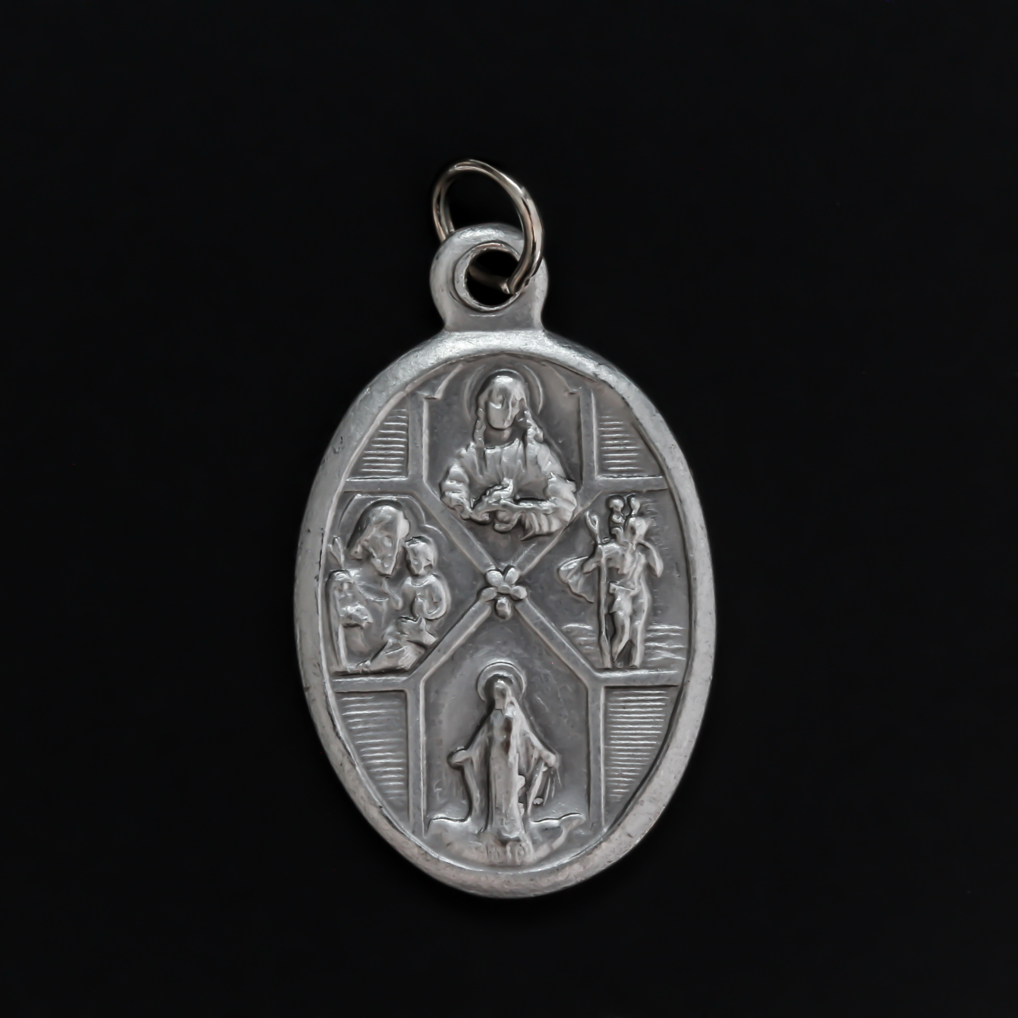 Silver oxidized detailed four-way medal that bears the Miraculous Medal, Sacred Heart Scapular Medal, St. Christopher medal, and a St. Joseph medal
