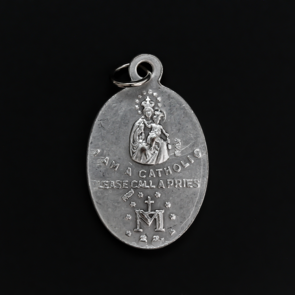 Silver oxidized detailed four-way medal that bears the Miraculous Medal, Sacred Heart Scapular Medal, St. Christopher medal, and a St. Joseph medal