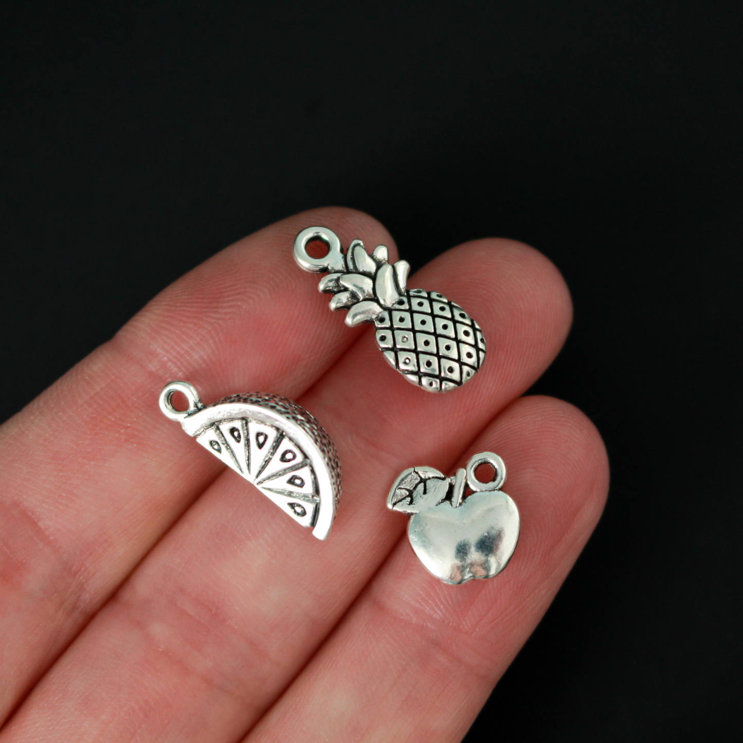 The Fruits of the Holy Spirit charm set. The set consists of 9 fruit charms that are Antiqued silver tone in color
