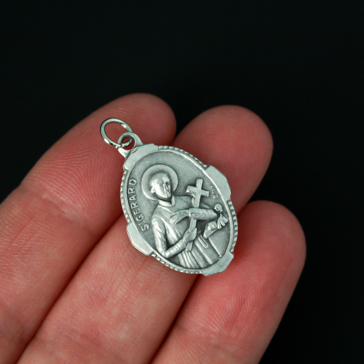 Saint Gerard Majella deluxe ornate medal that depicts the saint holding a cross on the front and "Pray For Us" on the back