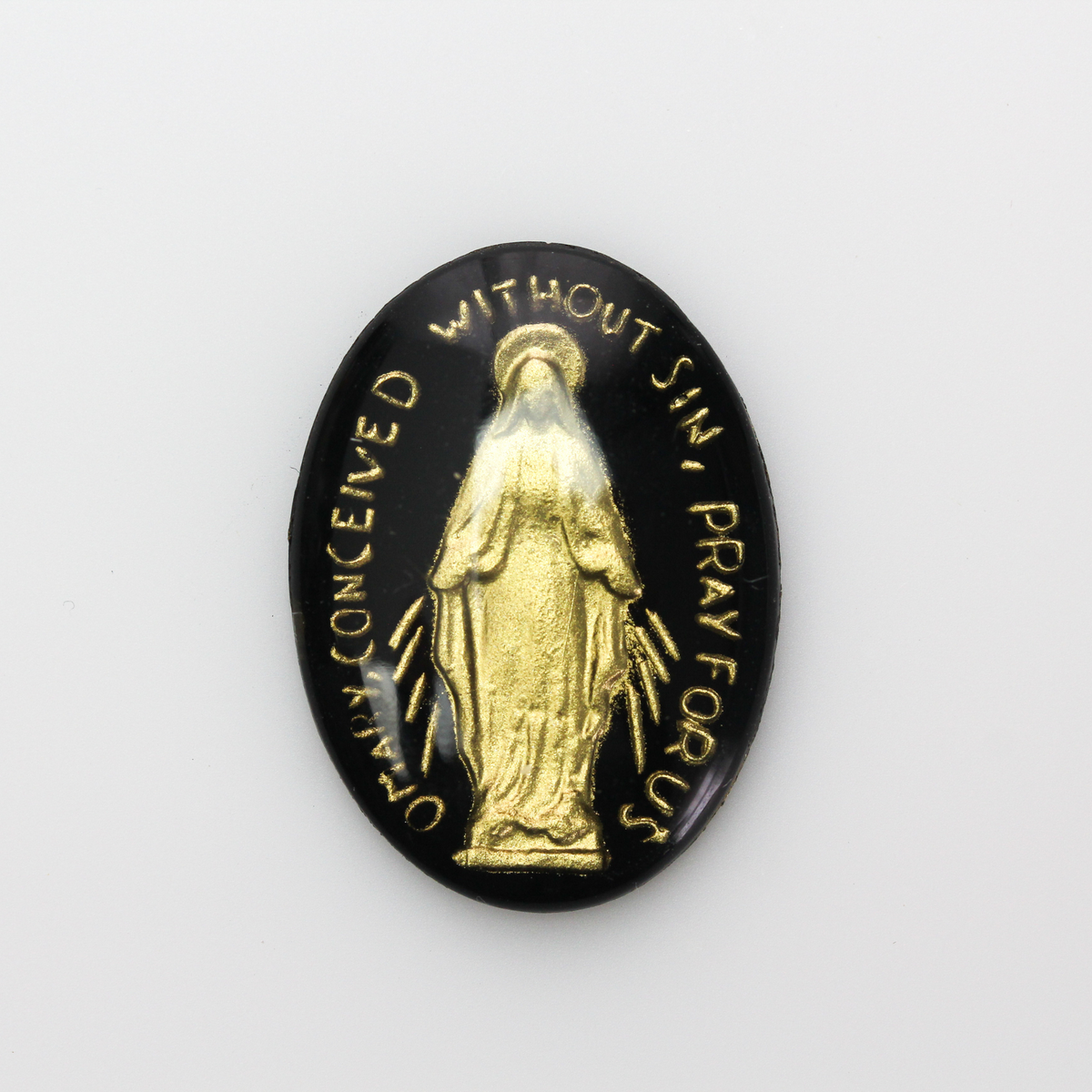 Glass cabochon of the Miraculous medal in a gold and black design. Hand pressed and painted in the Czech Republic