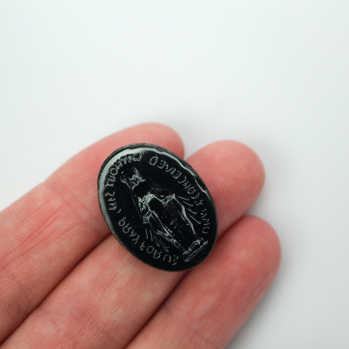 Glass cabochon of the Miraculous medal in a gold and black design. Hand pressed and painted in the Czech Republic