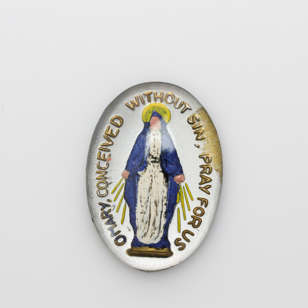 Glass cabochon of the Miraculous medal in a blue and silver design. Hand pressed and painted in the Czech Republi