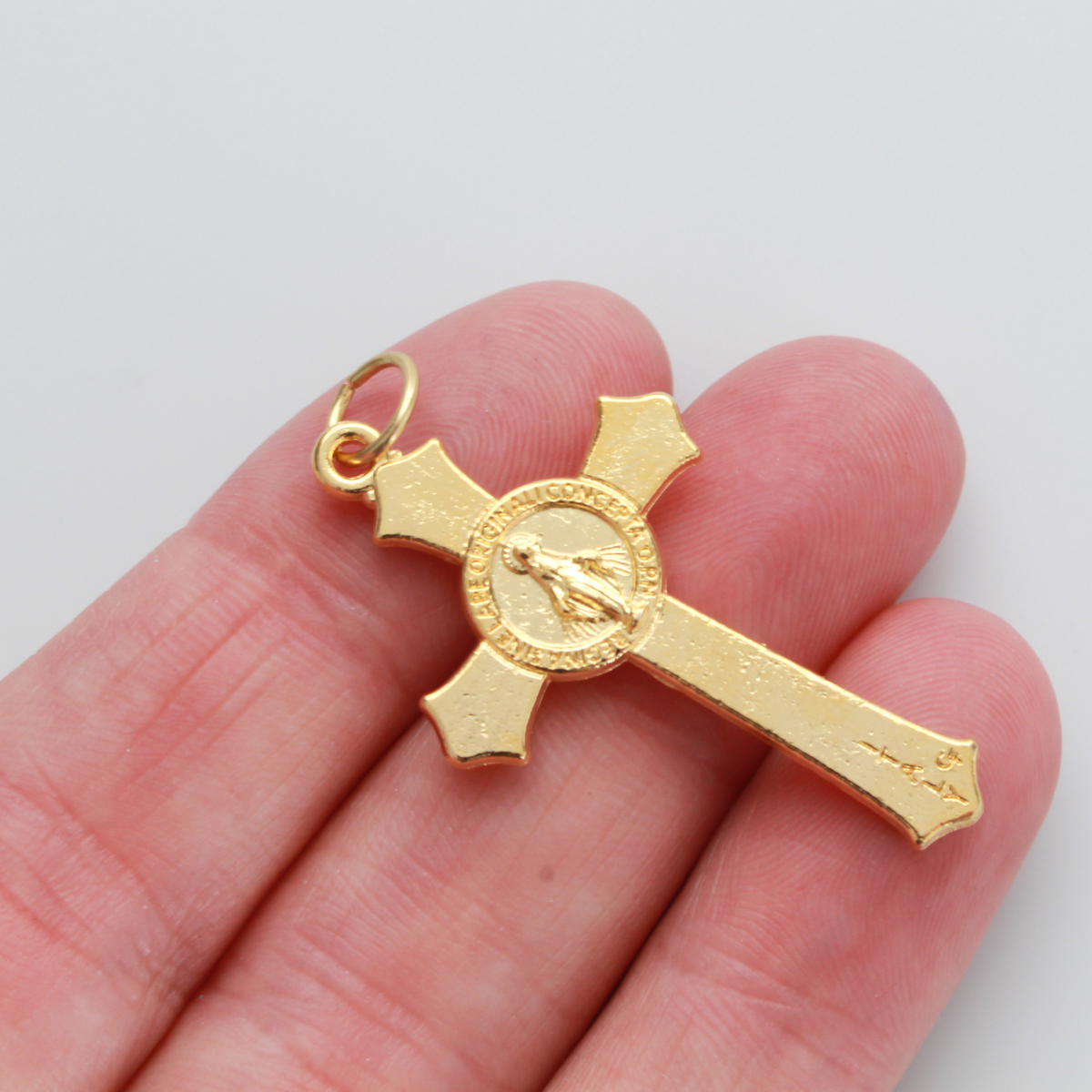 Gold Miraculous Medal crucifix that features flared edges and a detailed Miraculous Medal, front and back