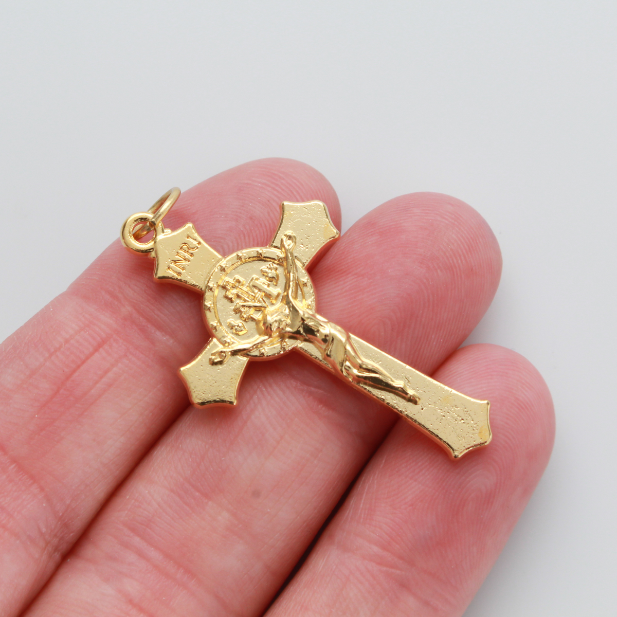Gold Miraculous Medal crucifix that features flared edges and a detailed Miraculous Medal, front and back