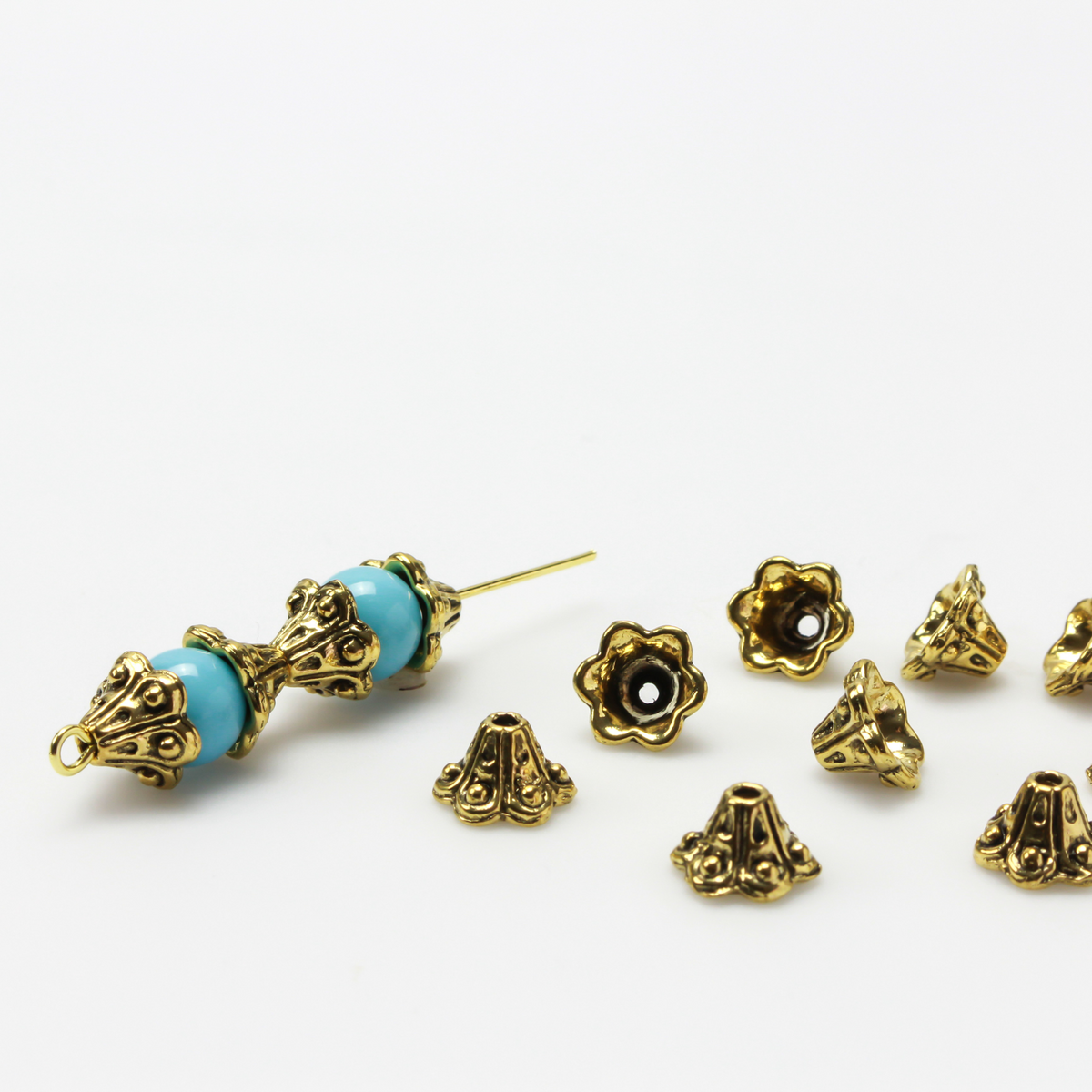 Bell flower shaped bead caps that will fit beads 8mm - 10mm. Shown on an 8mm glass bead for size reference. Sold in packages of 50 caps