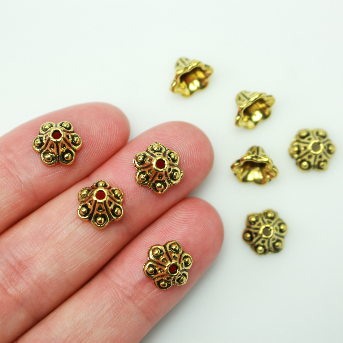 Bell flower shaped bead caps that will fit beads 8mm - 10mm. Shown on an 8mm glass bead for size reference. Sold in packages of 50 caps