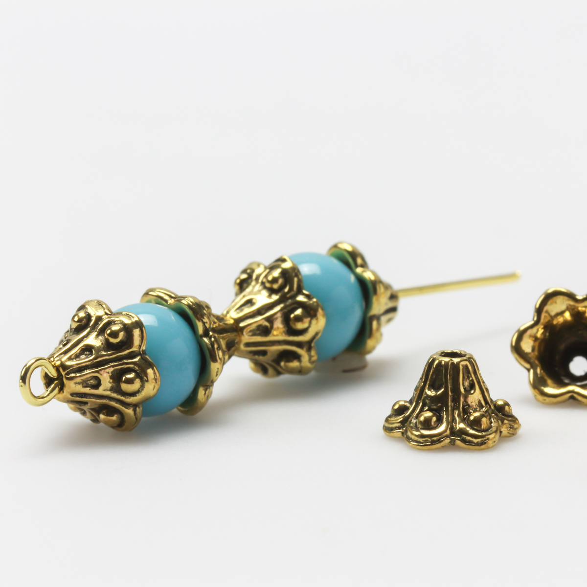 Bell flower shaped bead caps that will fit beads 8mm - 10mm. Shown on an 8mm glass bead for size reference. Sold in packages of 50 caps