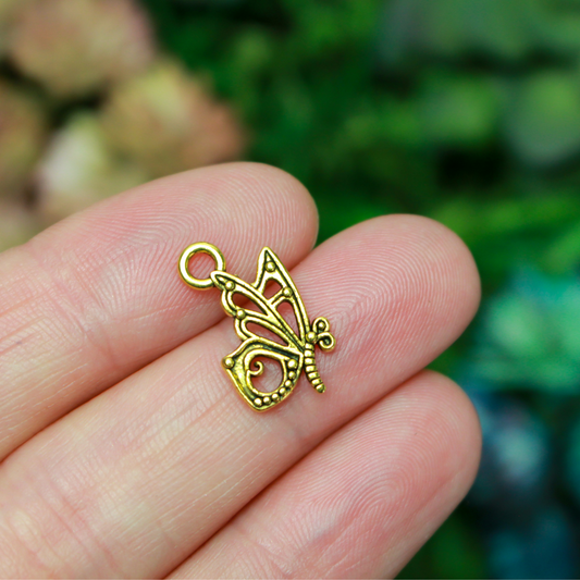 Butterfly charms in an antiqued golden finish, 16mm long