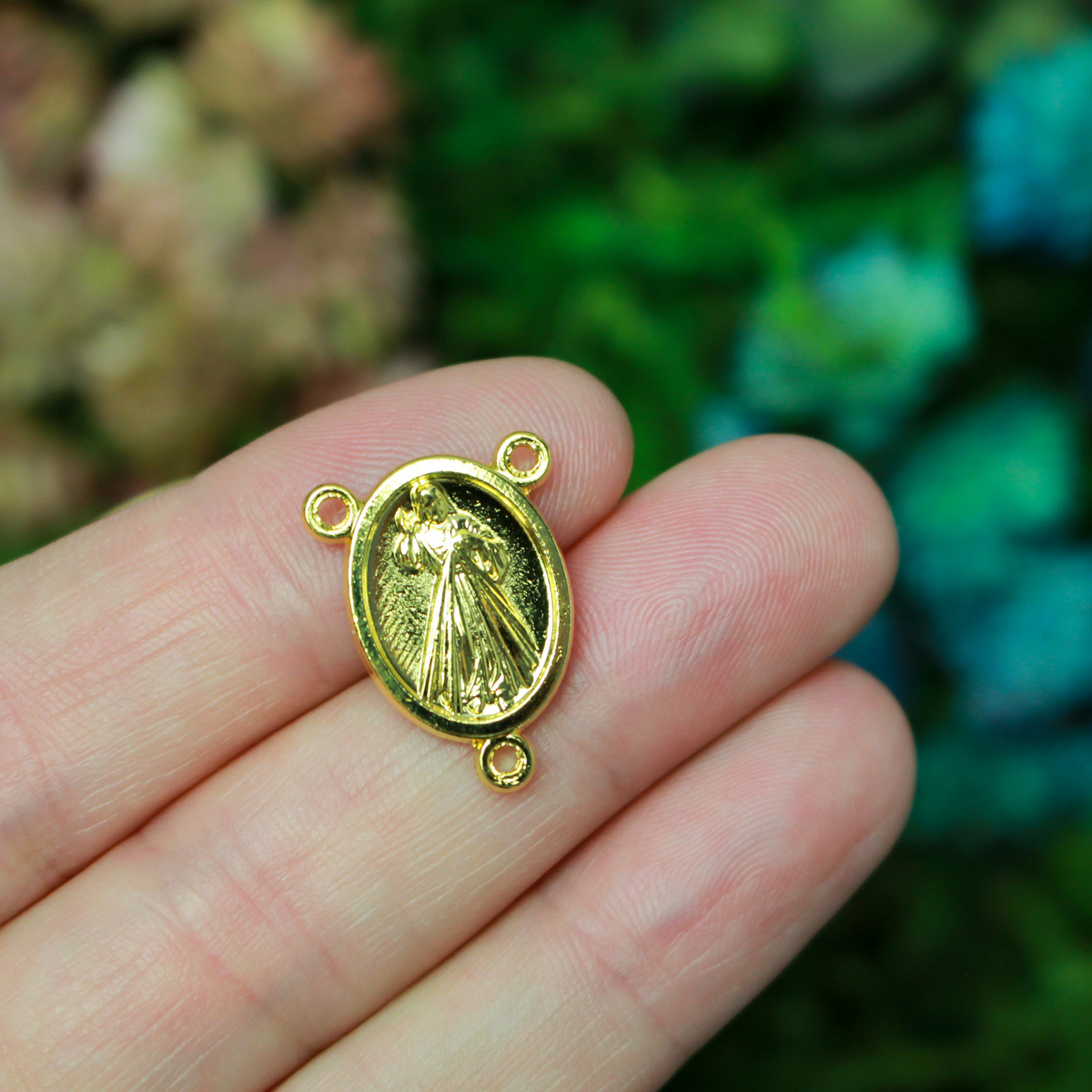Gold tone rosary centerpiece that features Divine Mercy on the front and Our Lady of Medjugorje on the back