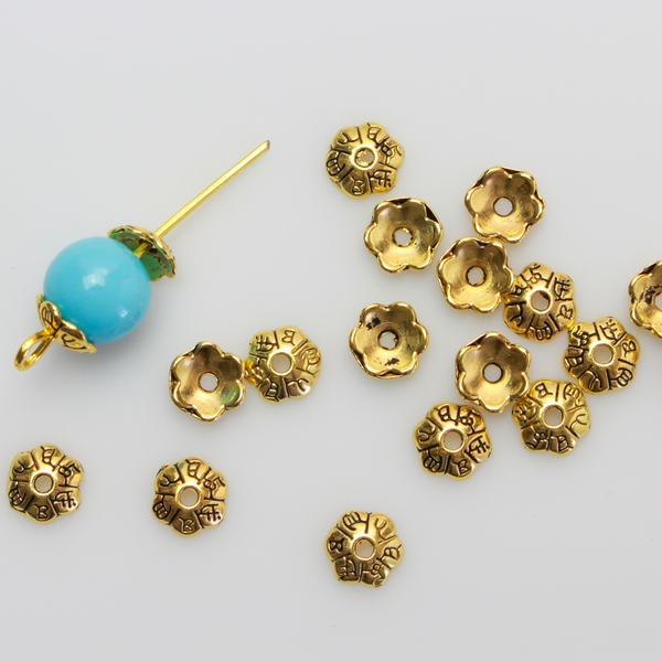 Flower shaped zinc alloy antiqued golden bead caps that are 6mm in diameter. They can fit beads 6mm - 10mm