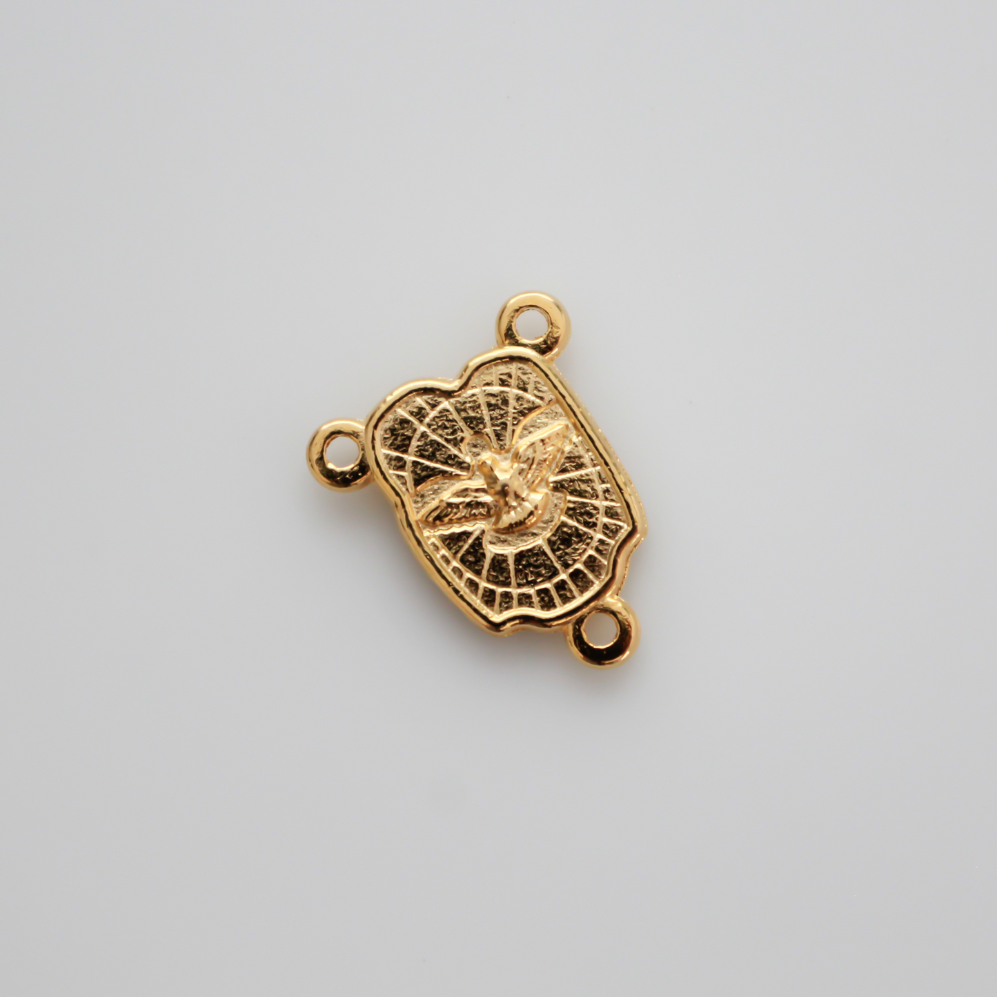 Gold-tone rosary centerpiece features an image of the Holy Family on the front and an image of the Holy Spirit on the back