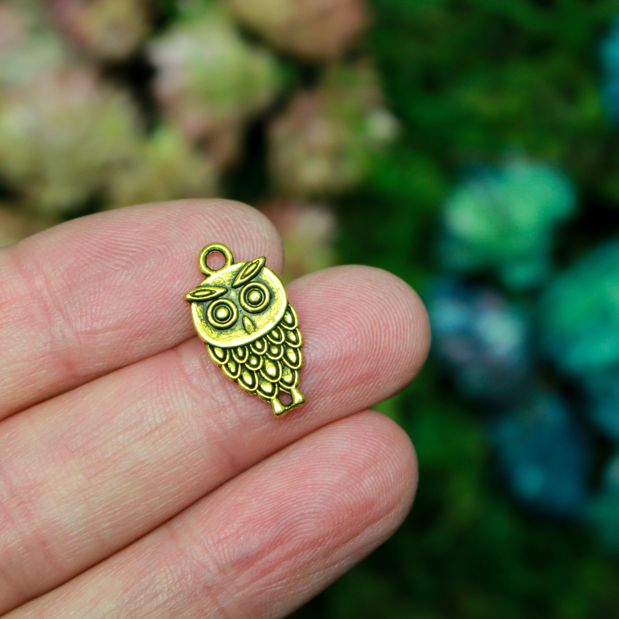 Small owl charm in an antiqued gold tone color, 18mm long