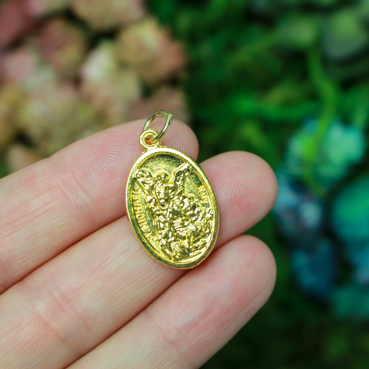 Gold tone Archangel Michael double-sided oval medal. The front depicts St. Michael and the reverse depicts a guardian angel