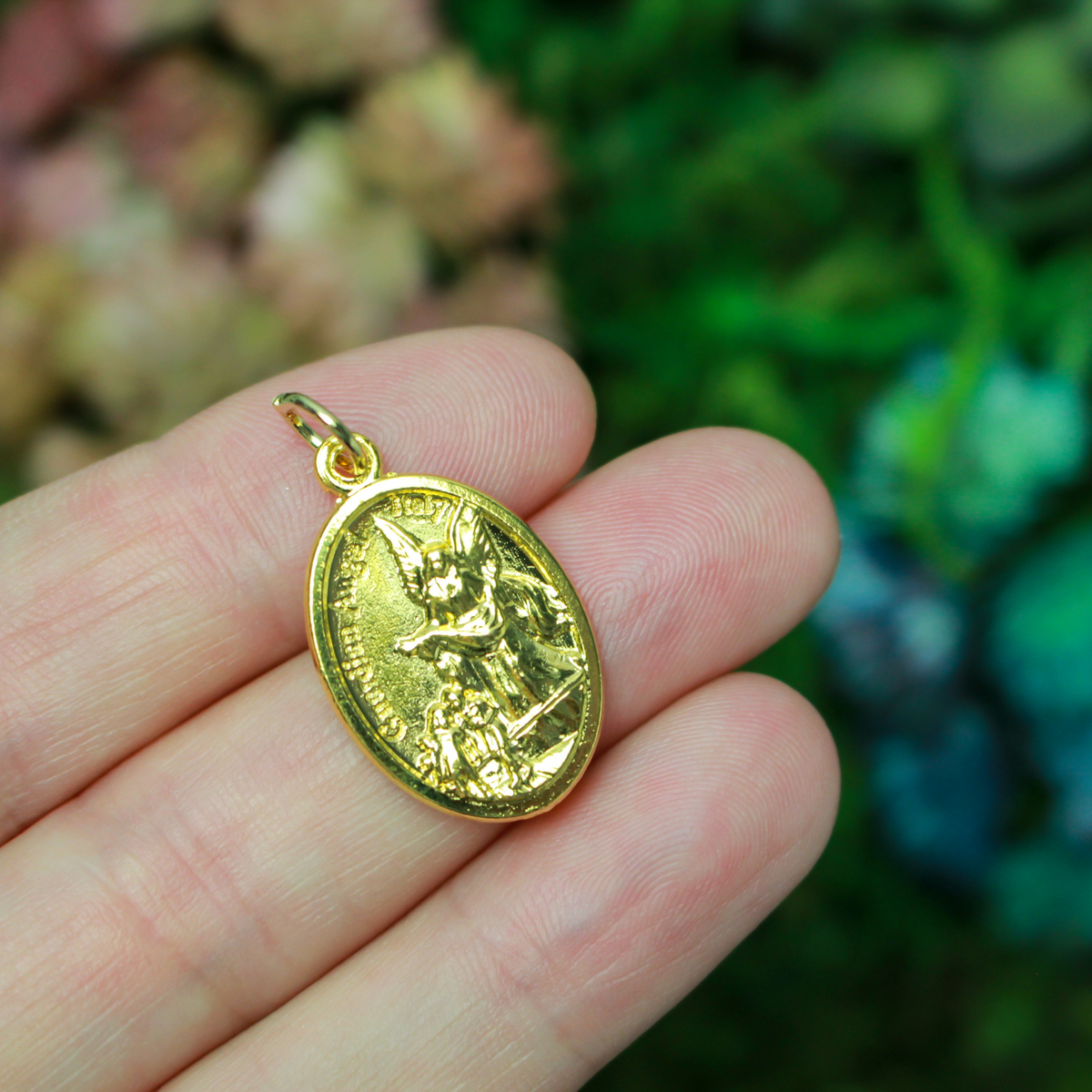 Gold tone Archangel Michael double-sided oval medal. The front depicts St. Michael and the reverse depicts a guardian angel