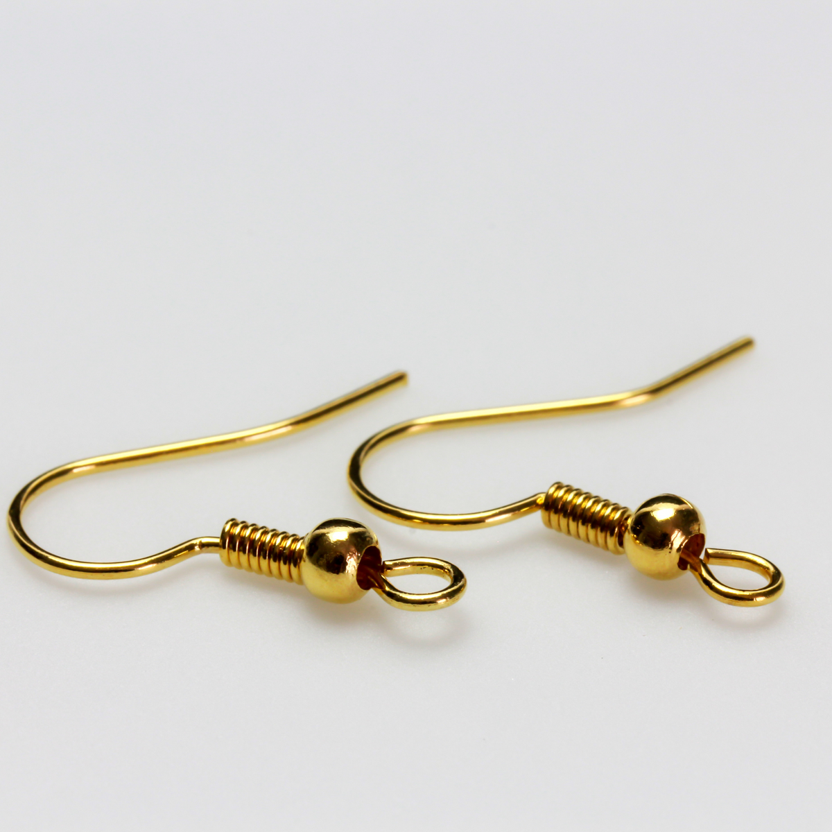 Brass earring hooks with a horizontal loop and a shiny golden finish, 21 gauge wire. Sold in packages of 30 hooks (15 pairs).