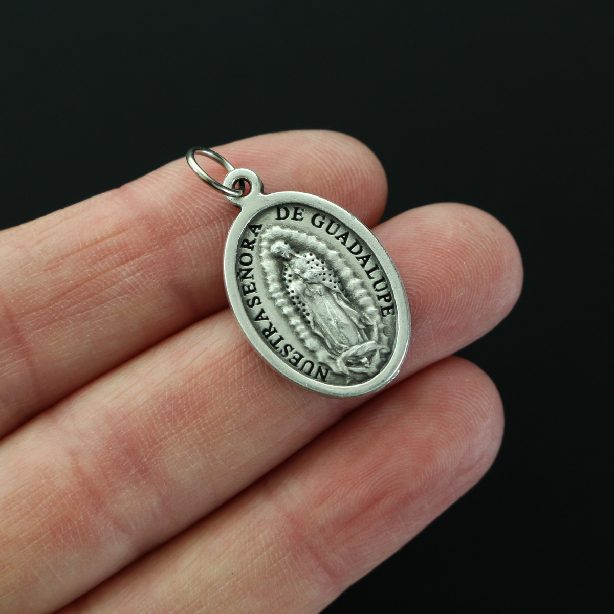 Our Lady of Guadalupe medal with the Divine Mercy of Jesus on the backside.