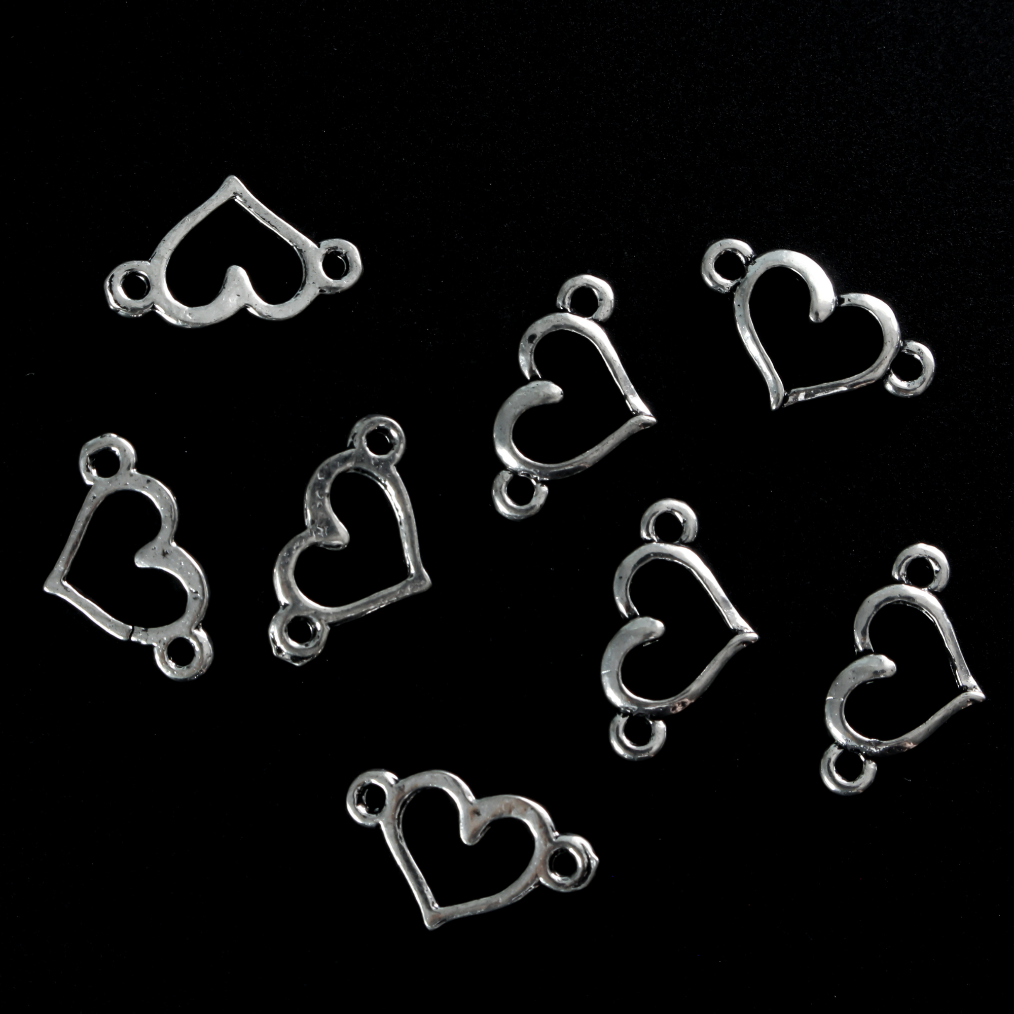 Hollow heart connector links that are sold in packs of 20 pieces.