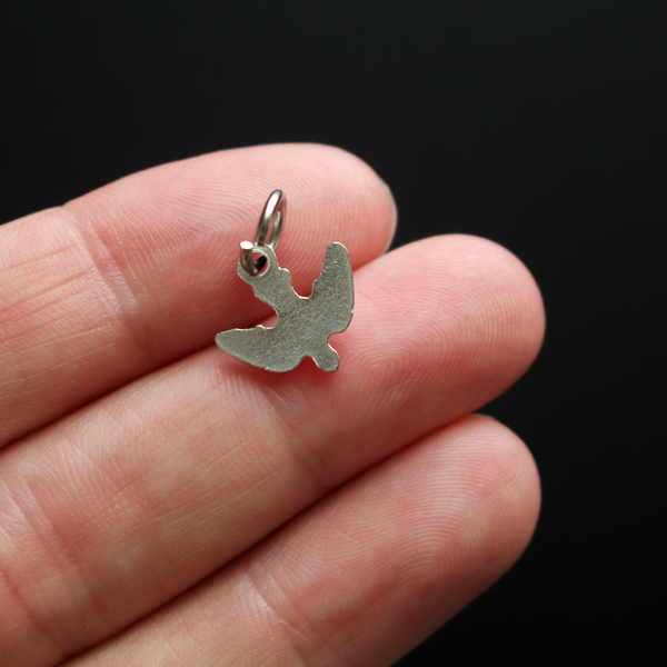 Tiny silver holy spirit dove charm with nice detail