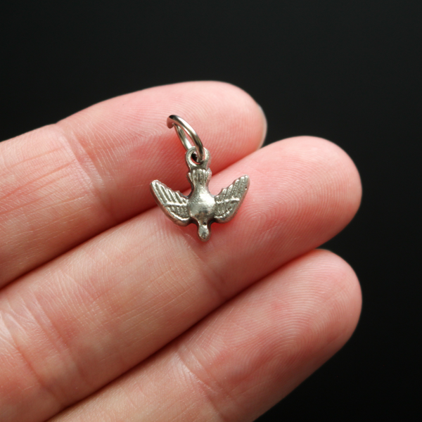 Tiny silver holy spirit dove charm with nice detail